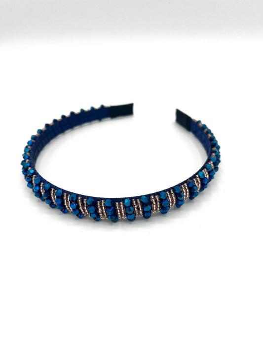 Smalle blauwe haarband met gouden sprankelende kralen